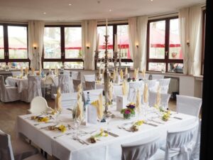 A beautifully arranged dining room with elegant table settings ready for a special event or celebration.